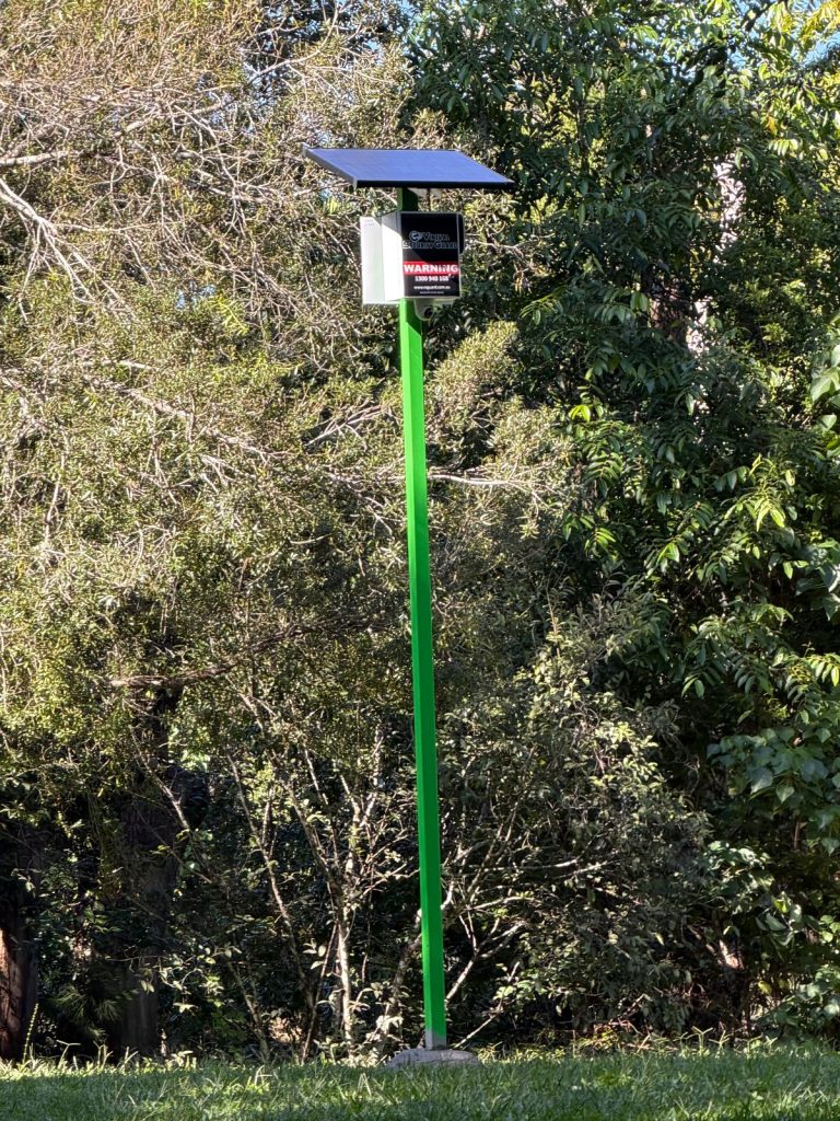 VSG green solar CCTV pole concreted into the ground beside bushland