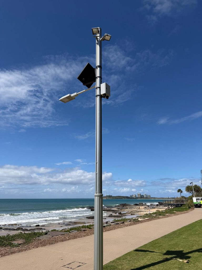 Colour-matched solar CCTV system on a public foreshore light pole overlooking the beach